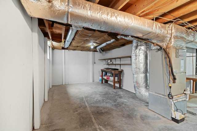 unfinished below grade area featuring heating unit