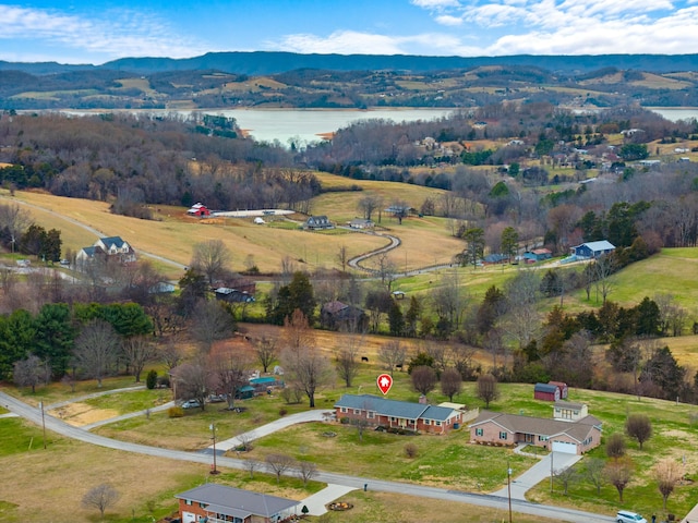 birds eye view of property featuring a water and mountain view