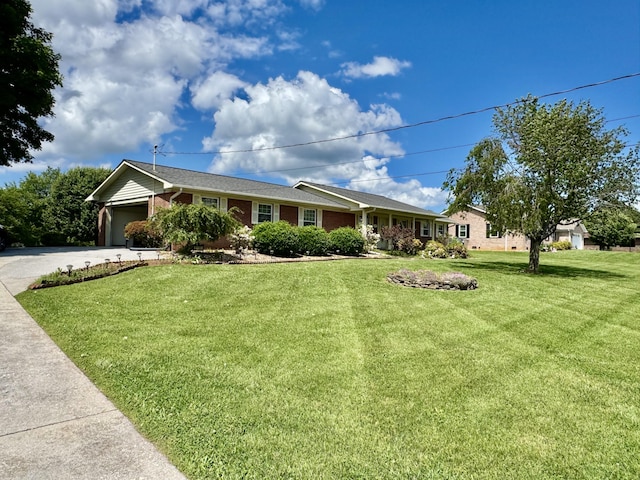 ranch-style house with brick siding, a garage, driveway, and a front lawn
