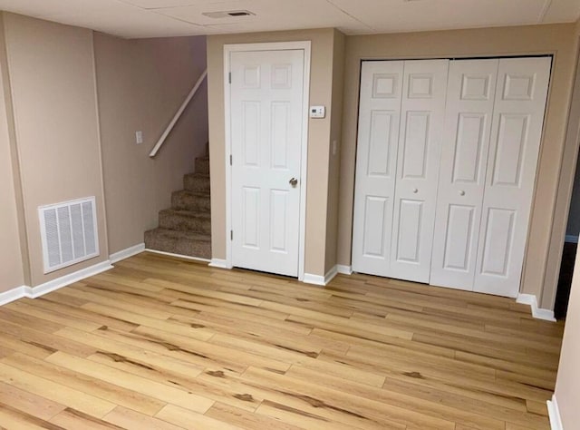 unfurnished bedroom featuring a closet and light hardwood / wood-style flooring