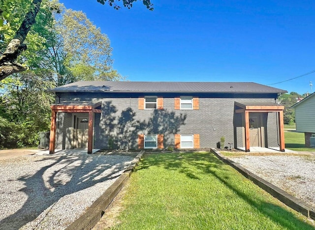 rear view of house with a lawn