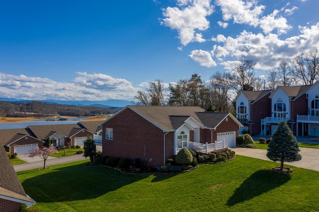 view of front of house with a mountain view, a garage, and a front lawn