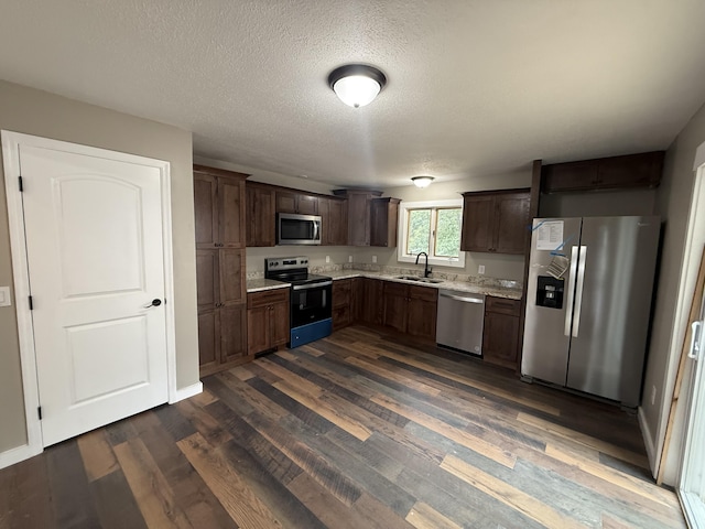 2157 Windy Cove Ln, Talbott, TN 37877 - kitchen featuring stainless steel appliances, dark wood-style floors, dark brown cabinetry, and a textured ceiling