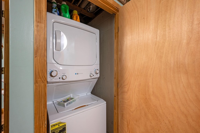laundry area featuring stacked washing maching and dryer