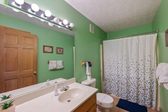 bathroom with vanity, a shower with curtain, toilet, and a textured ceiling