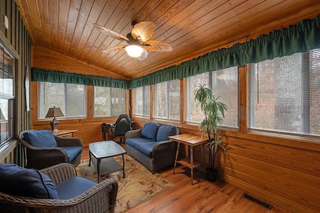 sunroom / solarium with ceiling fan, lofted ceiling, and wood ceiling