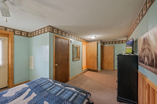 carpeted bedroom featuring a textured ceiling, ceiling fan, and a closet