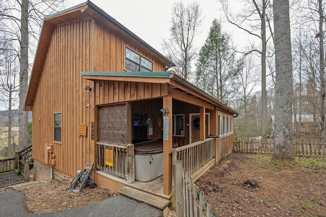 view of home's exterior with a hot tub