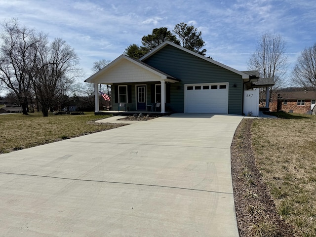 view of front of property with a garage, driveway, a porch, and a front lawn