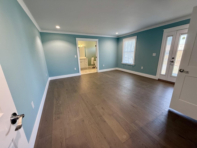 interior space featuring dark wood-style floors, crown molding, and baseboards