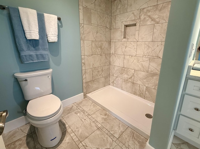 bathroom featuring toilet, marble finish floor, and baseboards