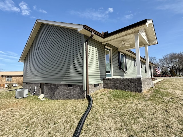 view of home's exterior featuring crawl space, a lawn, and central AC unit