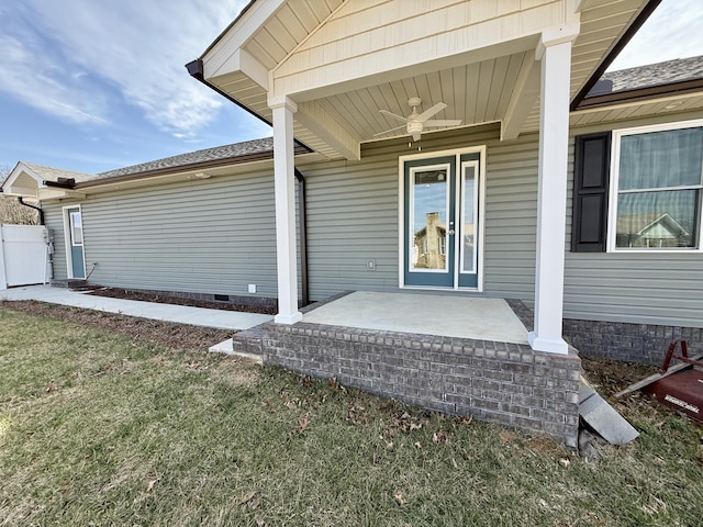 property entrance with crawl space, covered porch, ceiling fan, and a lawn