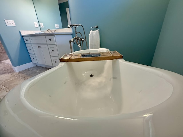 full bathroom with a soaking tub and vanity