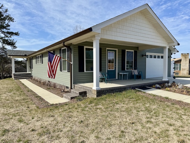 view of front facade with a porch, a front lawn, and a garage