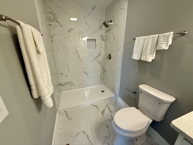 full bath featuring a marble finish shower, marble finish floor, baseboards, and toilet