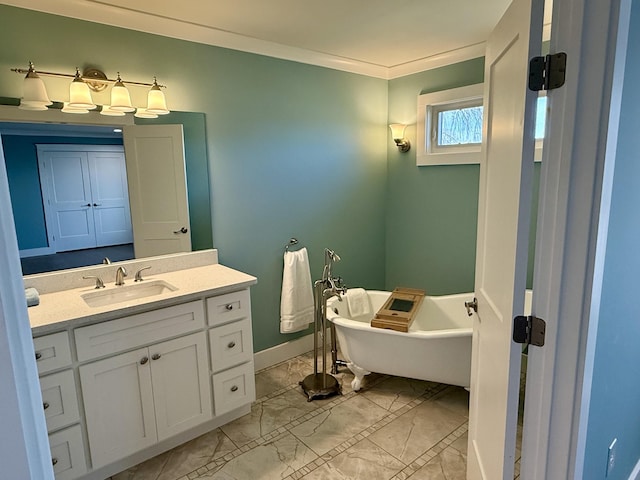 bathroom featuring baseboards, a soaking tub, ornamental molding, marble finish floor, and vanity