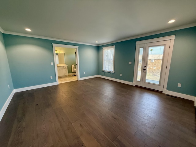 unfurnished room with visible vents, baseboards, and dark wood-style flooring