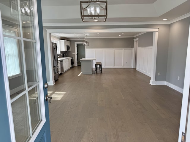 interior space featuring a chandelier, recessed lighting, crown molding, and dark wood finished floors