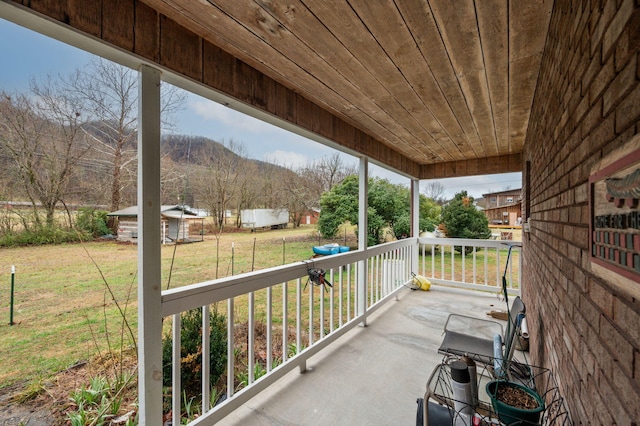 balcony with a porch and a mountain view