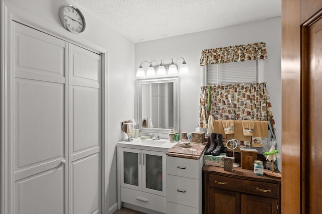 bathroom with a textured ceiling and vanity