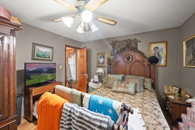 bedroom with a ceiling fan and light wood finished floors