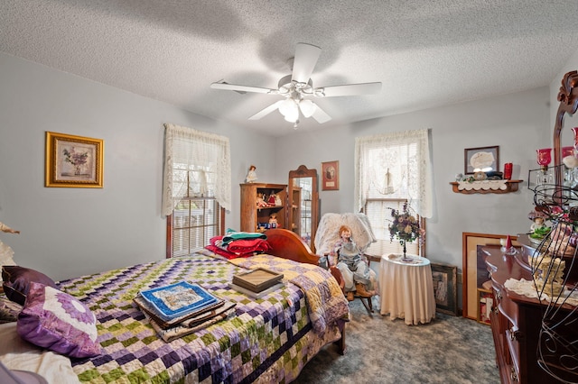 carpeted bedroom featuring a ceiling fan and a textured ceiling