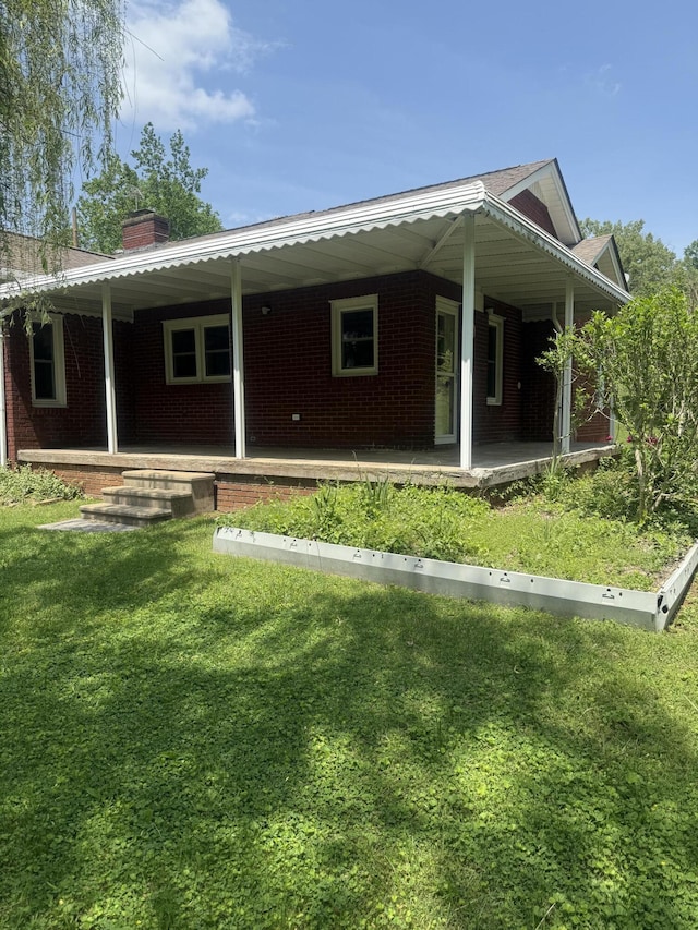 240 Clifton Heights Rd, Newport, TN 37821 - view of front of home featuring brick siding, a front lawn, covered porch, and a chimney