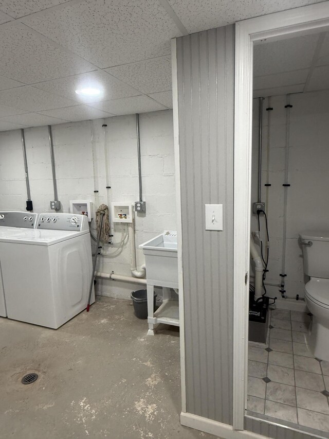 240 Clifton Heights Rd, Newport, TN 37821 - washroom with concrete block wall, laundry area, washing machine and dryer, and a sink