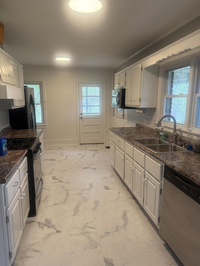240 Clifton Heights Rd, Newport, TN 37821 - kitchen with dark countertops, a sink, marble finish floor, stainless steel appliances, and backsplash