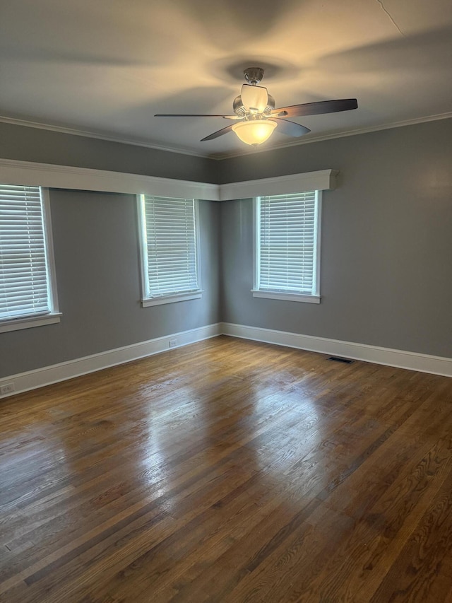 240 Clifton Heights Rd, Newport, TN 37821 - spare room featuring crown molding, plenty of natural light, a ceiling fan, visible vents, and dark wood-style floors