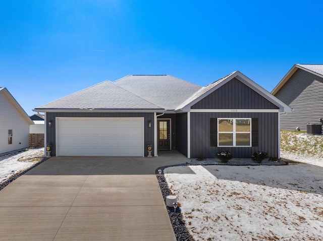 single story home featuring a garage, board and batten siding, a shingled roof, and concrete driveway