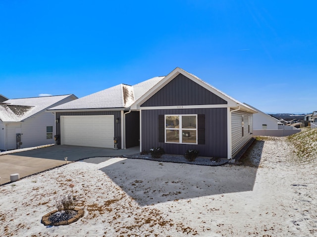 view of front of home with a garage, driveway, and board and batten siding