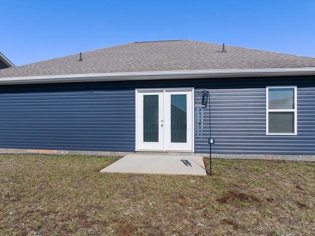 back of house with french doors, roof with shingles, and a lawn