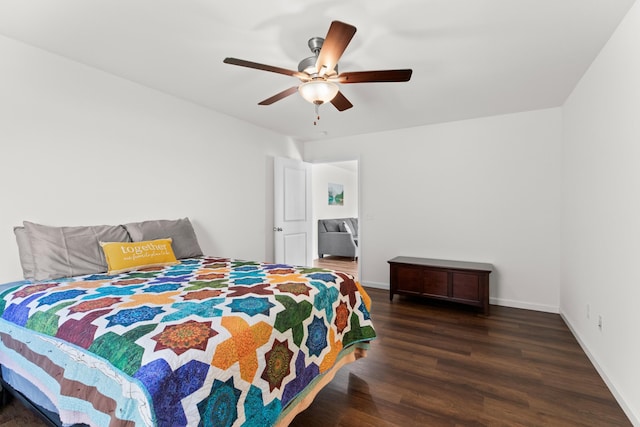 bedroom featuring dark wood-style floors, a ceiling fan, and baseboards