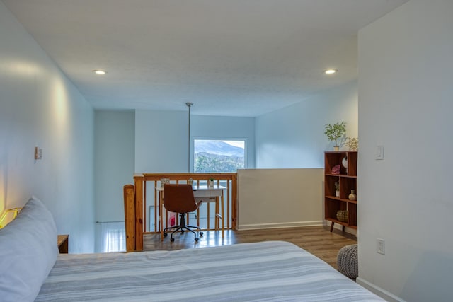 bedroom with recessed lighting, wood finished floors, and baseboards