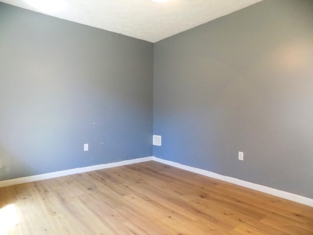 unfurnished room featuring light hardwood / wood-style floors