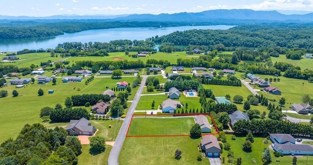 aerial view featuring a water and mountain view