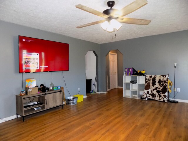 misc room featuring ceiling fan, hardwood / wood-style floors, and a textured ceiling