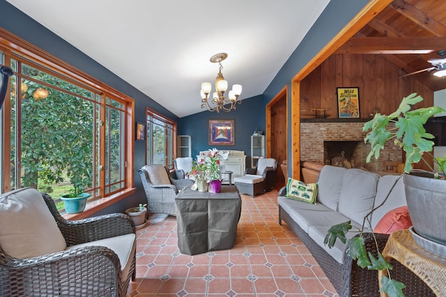 living room featuring a notable chandelier, a fireplace, lofted ceiling with beams, wood walls, and tile patterned flooring