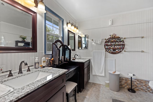 bathroom featuring two vanities and a sink