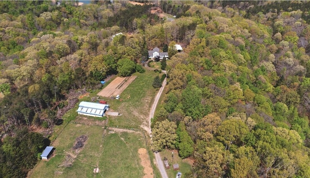 birds eye view of property with a wooded view