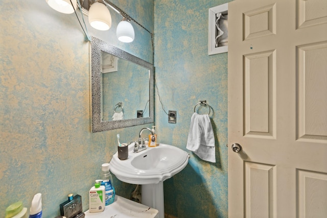 bathroom with wallpapered walls