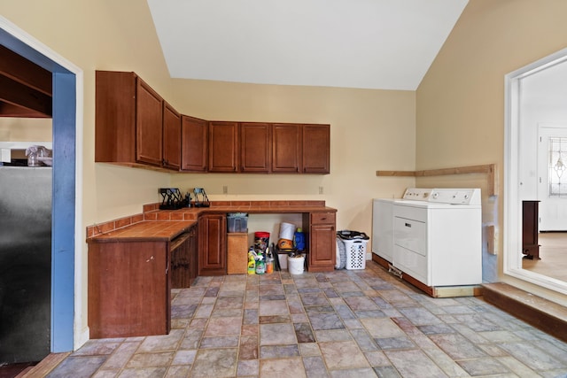 interior space featuring washing machine and dryer and stone finish flooring