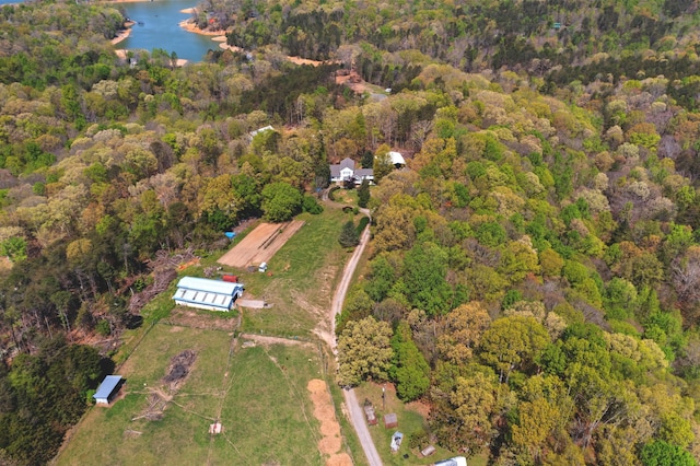 bird's eye view with a water view and a wooded view