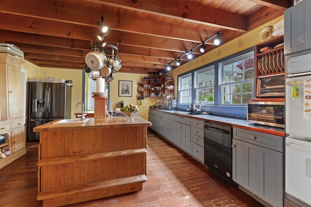 kitchen featuring open shelves, appliances with stainless steel finishes, gray cabinets, and a sink