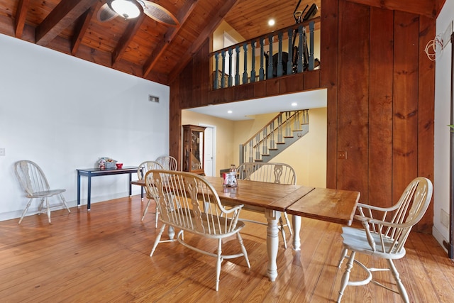 dining space featuring wood ceiling, ceiling fan, wood finished floors, beamed ceiling, and stairs