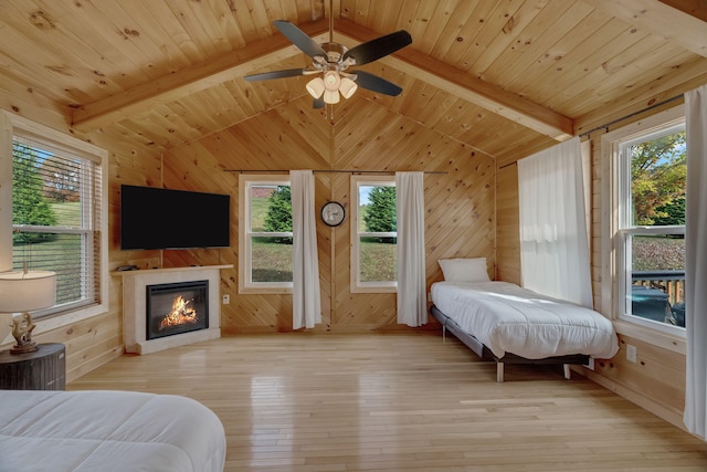 bedroom with light wood-type flooring, vaulted ceiling with beams, ceiling fan, and wooden ceiling