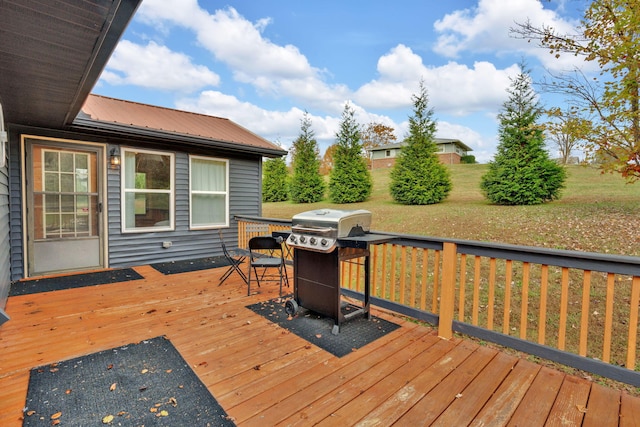 wooden deck featuring a grill