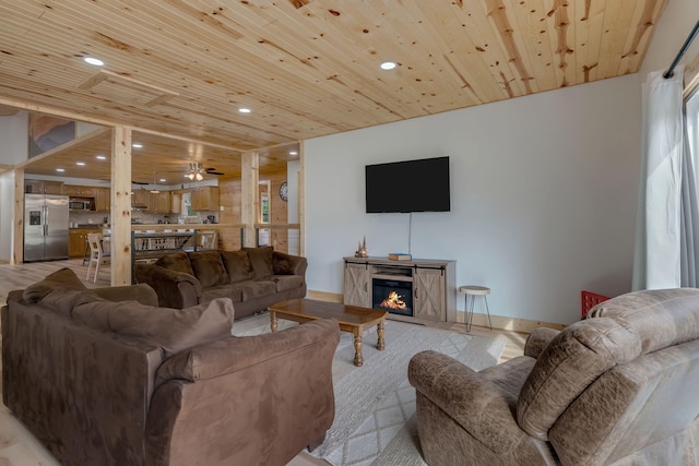 living room with ceiling fan and wooden ceiling